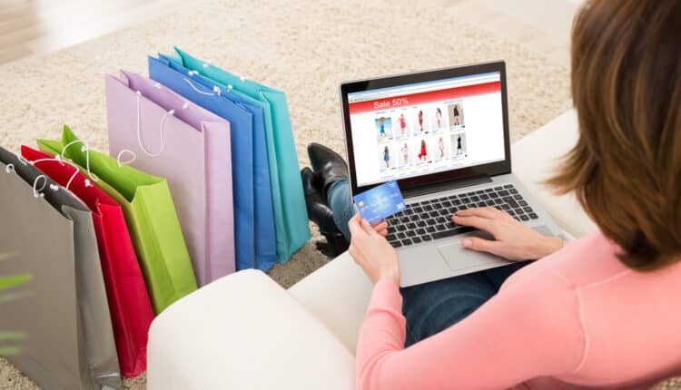 Young,Woman,On,Sofa,Shopping,Online,With,Debit,Card